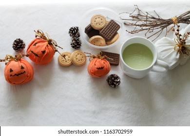 Halloween Theme Snacks Of Pumpkin Biscuits And Macha Tea