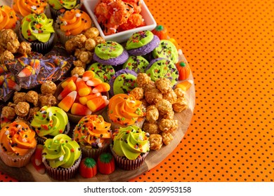 Halloween Themed Charcuterie Board On An Orange And Black Polkadot Background