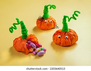 halloween treats for kids wrapped in the shape of pumpkins. Party favor bag with colorful candy. Trick or Treat, concept for Halloween - Shutterstock ID 2203640513