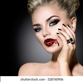Halloween Vampire Woman make up. Beautiful sexy girl with Vampire makeup, black nails and and accessories