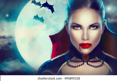 Halloween Vampire Woman portrait over scary night background. Beauty Sexy Vampire Girl with dripping blood on her mouth. Vampire makeup Fashion Art design. Model girl in Halloween costume and make up