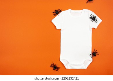 Halloween White Baby Girl Or Boy Bodysuit Mockup Flat Lay With Spiders On Orange Background. Design Onesie Template, Print Presentation Mock Up. Top View. 