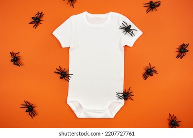 Halloween White Baby Girl Or Boy Bodysuit Mockup Flat Lay With Spiders On Orange Background. Design Onesie Template, Print Presentation Mock Up. Top View. 