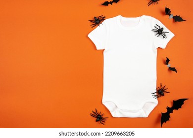 Halloween White Baby Girl Or Boy Bodysuit Mockup Flat Lay With Spiders And Bats On Orange Background. Design Onesie Template, Print Presentation Mock Up. Top View. 