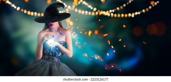 Halloween Witch girl with making witchcraft, magic in her hands, spells. Beautiful young woman in witches hat conjuring. Spooky dark magic forest background. Magician. Wide Halloween party art design.
