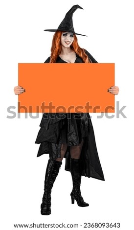 Halloween Witch Woman with long red hair and holiday make-up wearing dark tapered witch's hat. Beauty gothic girl in Party Celebrating All Saints' Day art design