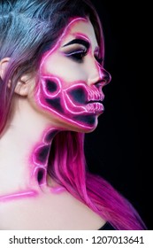 
Halloween. Woman in day of the dead mask skull face art. Pink and black skull make up.