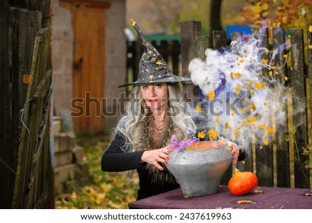Halloween a woman with a magic bowler hat witch conjures, performs witchcraft in a creepy old magical house.