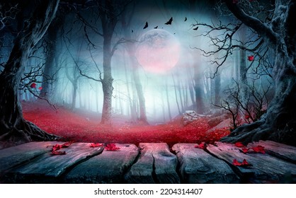 Halloween - Wooden Table In Spooky Forest At Nights With Red Leaves In Autumn Landscape At Moonlight - Shutterstock ID 2204314407