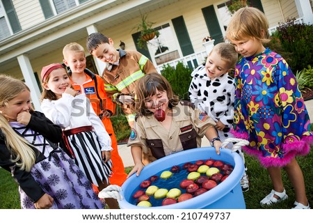 Halloween: Young Girl Gets Soaked Bobbing For Apples At Party