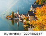 Hallstatt village in Austrian Alps. Houses and mountains are reflected in the lake. Beautiful autumn landscape