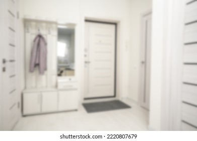 Hallway In Apartment Blurred Background. Small Entrance Hall In Light Beige Tones Blurred Background. Defocused Condo Hall