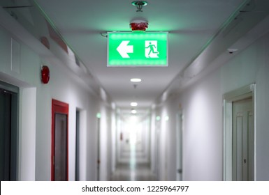 Hallway In Apartment With , Door Rooms In Dorm Fire Exit Green Light Sign