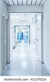 hallway with the door open to the intensive care unit at the hospital with doctors blurred
