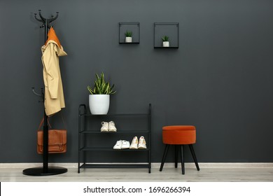 Hallway interior with stylish furniture, clothes and accessories - Shutterstock ID 1696266394