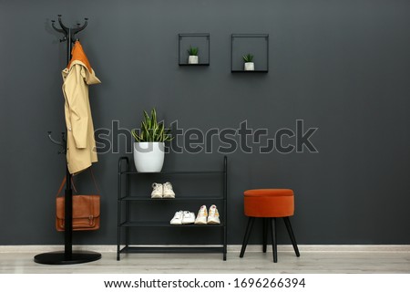 Hallway interior with stylish furniture, clothes and accessories