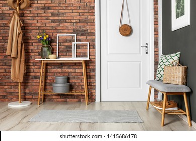 Hallway interior with stylish table and bench