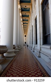 Hallway With Ornate Ceiling, Floor, And Pillars