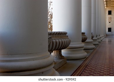 Hallway With Ornate Ceiling, Floor, And Pillars