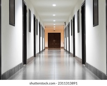 The hallway stretches out before me, a pathway connecting different spaces and serving as a thoroughfare within the building. Lined with doors and adorned with artwork or decorative accents,  - Powered by Shutterstock