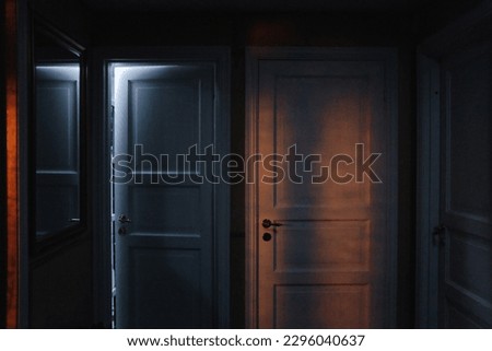  hallway, three closed doors with atmospheric light at night