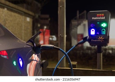 Halmstad, Halland, Sweden - January 31, 2022: Image was taken on the evening of the 31st January 2022, in the center of the city. Image presents a free charging station for electric cars. 