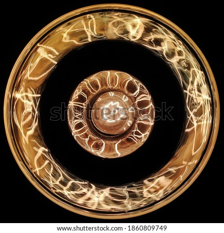 Halogen bulb, yeallow light at night, bottom view of fillament bulb, glowing bulb