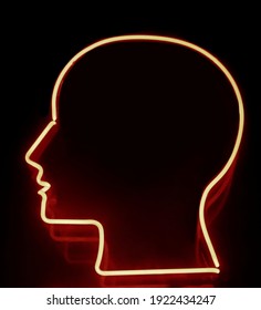 Halogen Red Lamp In The Form Of Human Head. Open Mind. Illumination Of Customized Neon Light. Isolated On Black Background.