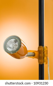 Halogen Spot Clamp Lamp Over A Orange Background