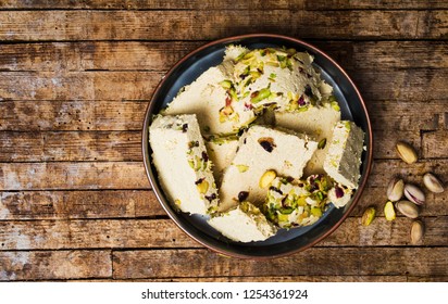 Halva With Pistachio On A Rustic Wooden Table