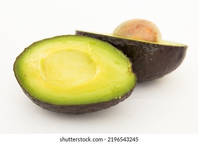 halved avocado with bone on white background - Shutterstock ID 2196543245