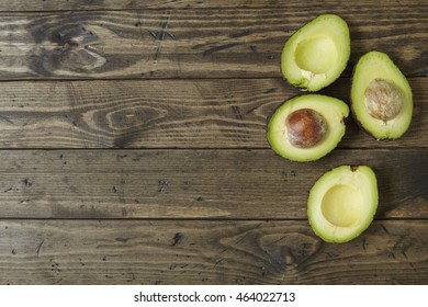 Halved Avocados On A Rustic Wooden Kitchen Counter Background Forming A Page Border