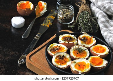 halved boiled eggs with shells. Stylish breakfast with eggs. Keto snack soft boiled eggs.