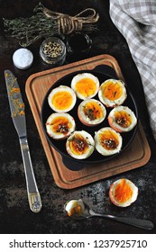 halved boiled eggs with shells. Stylish breakfast with eggs. Keto snack soft boiled eggs.