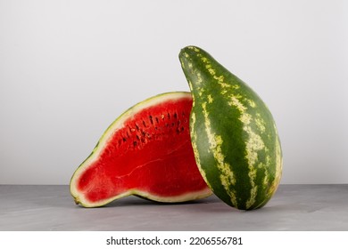 Halved Cut Of Pear-shaped Watermelon. Deformed Ugly Watermelon. Selective Focus. Concept - Food Waste Reduction. Eating Imperfect Foods.