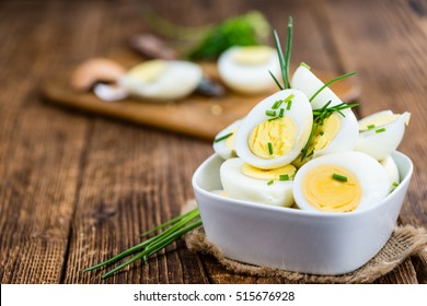 Halved Eggs on wooden background (close-up shot; selective focus) - Powered by Shutterstock