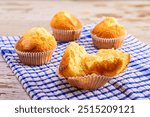 Halved Muffin with More in the Backgroundon a Kitchen Towel