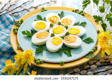 Halves of boiled eggs on a blue plate, close up view. Easter, a healthy snack - Powered by Shutterstock