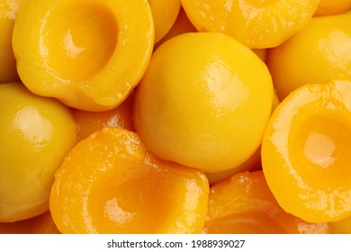 Halves of canned peaches as background, top view