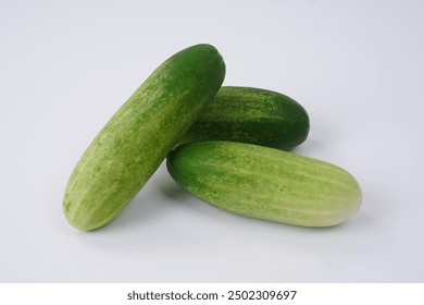 Halves and slices of long cucumber isolated on white background. Green cucumber texture template arranged and harvested. Fresh cucumbers picked from the garden and sold on the shelves in the market. - Powered by Shutterstock