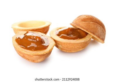 Halves of tasty walnut shaped cookies with boiled condensed milk on white background - Powered by Shutterstock