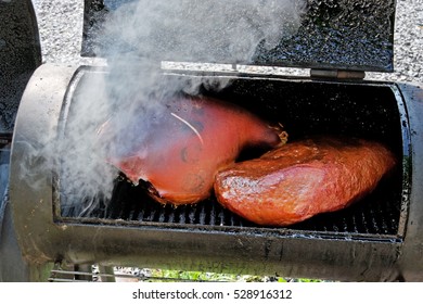 Ham And Brisket Inside Smoker. Horizontal.