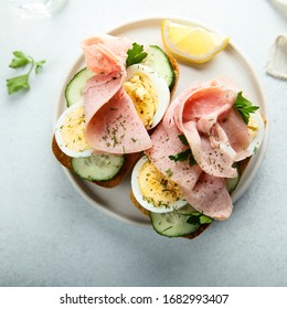 Ham and egg sandwiches on a white plate