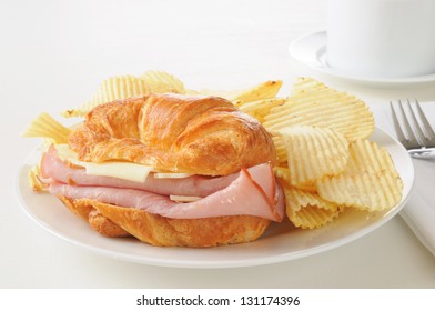 A Ham And Swiss Cheese Sandwich On A Croissant