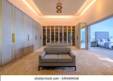 HAMALA, BAHRAIN - MARCH 02, 2019: The Closets In A Bespoke Dressing Room Of A Luxury Middle Eastern Villa Development Showing The Bedroom In The Background.