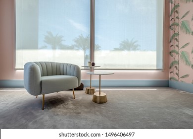 HAMALA, BAHRAIN - MARCH 02, 2019: Interior View Of An Armchair And Side Tables On A Gray Silk Carpet With Pink Bespoke Wallpaper In The Bedroom Of A Luxury Middle Eastern Villa Development.