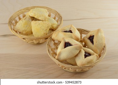 Hamantash And Scones In Wicker Baskets On Wooden Table