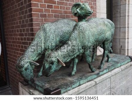 Hamburg / Germany - 07.07.2019: street scene - Street bronze sculpture - ram and two sheep, Hamburg,  Germany