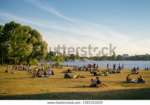 HAMBURG, GERMANY - 12.07.2018\
Hamburg public area\
with relaxing people on\
meadow