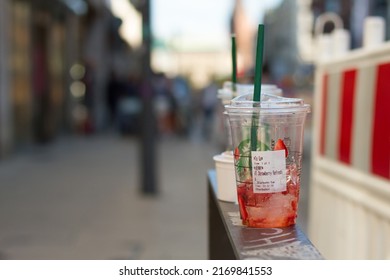 Hamburg, Germany 12.6.2022 Used Starbucks cup left on the street. Plastic drink cup litter in the city